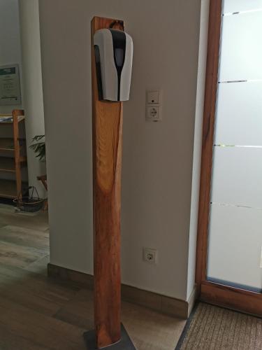 a tall wooden pole with a parking meter on the wall at Zauscherhof in Wildermieming