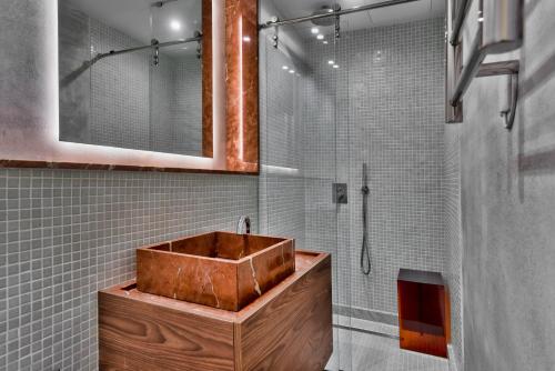 a bathroom with a wooden sink and a shower at Guest House de la Valette in Valletta
