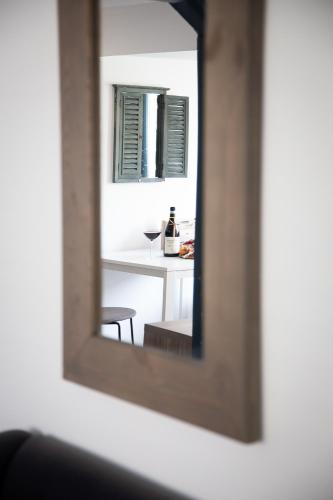 a mirror reflection of a table with a bottle of wine at Bed and Wine Nonsolovino in Reeuwijk