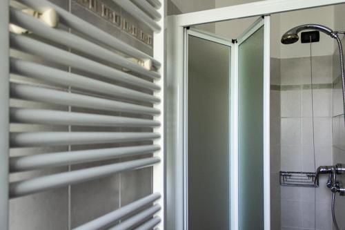 a bathroom with a shower and a window with blinds at La Vecchia Cantina in Stradella