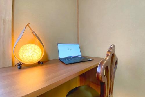 a laptop computer sitting on top of a wooden desk at Youan in Fujikawaguchiko