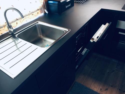 a kitchen counter with a stainless steel sink at Ski and Bike-In and Out in Hafjell