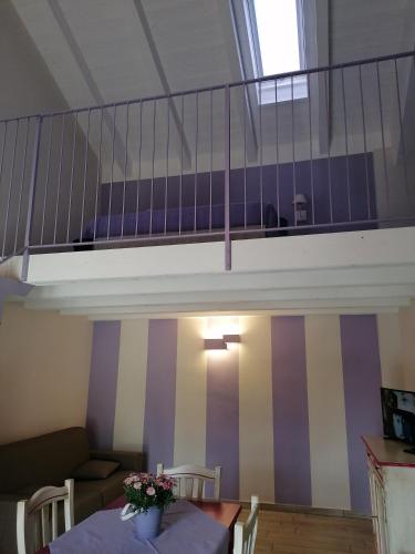 a living room with a table and a staircase at La Bella Vite in Moncalvo