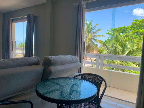 a living room with a couch and a glass table at Temporada Litorânea slz in São Luís