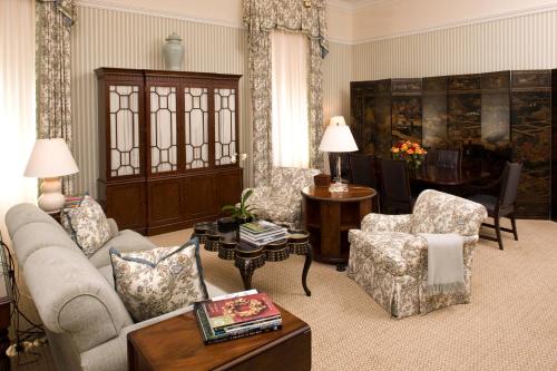 a living room with a couch and chairs and a table at Capital Hotel in Little Rock