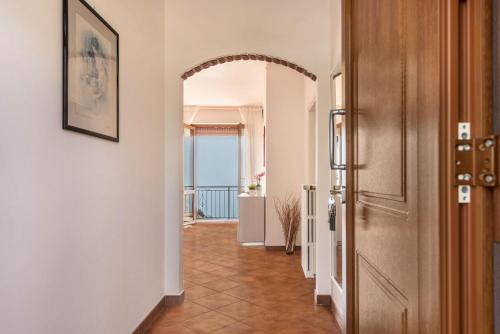 a hallway with a door and a tile floor at Bel Soggiorno lake view 1 in Tremosine Sul Garda