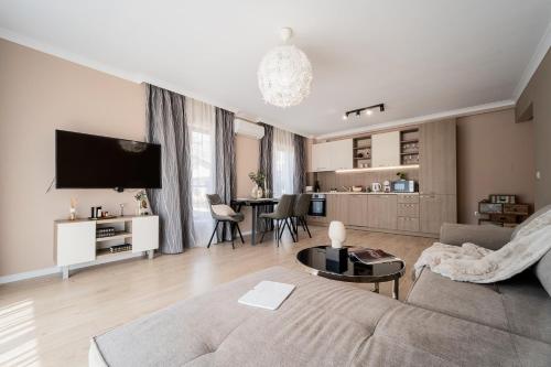 a living room with a couch and a table at Comfy luxury center apartment in Varna City