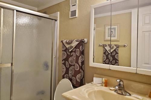 a bathroom with a shower and a sink and a toilet at Harbour Beach Resort Unit #818 in Daytona Beach