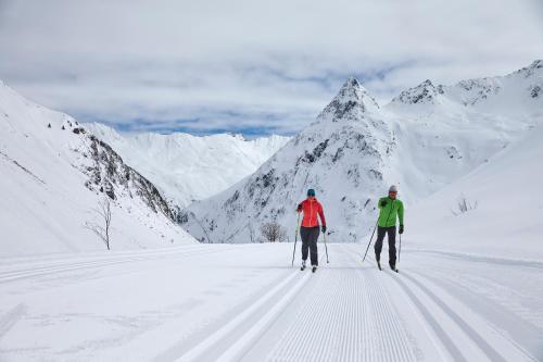two people cross country skiing on a snowy mountain at Apart Renate in Galtür