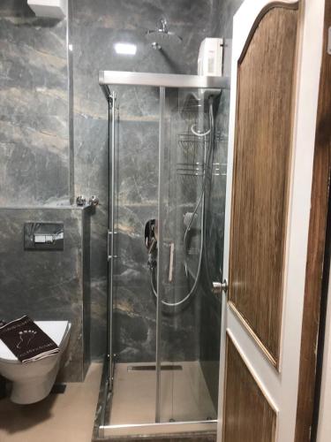 a shower with a glass door in a bathroom at Speedy Apart Otel in Marmaris