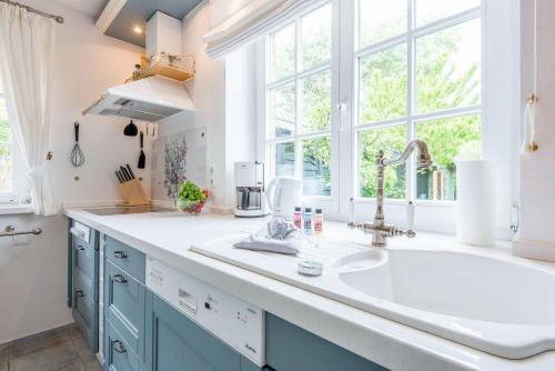 a kitchen with a sink and a large window at Wenningstedter Weg Haushaelfte B in Westerland (Sylt)