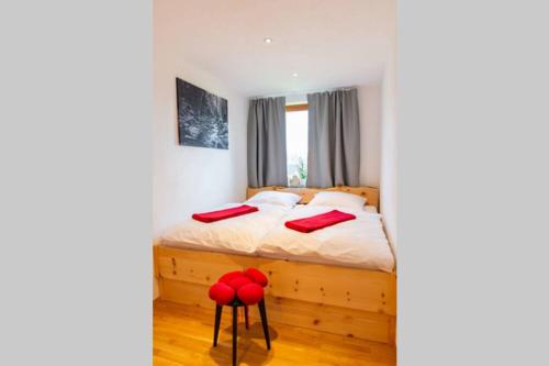 a bedroom with a bed with red pillows at Appartement Bergsonne in Sankt Märgen