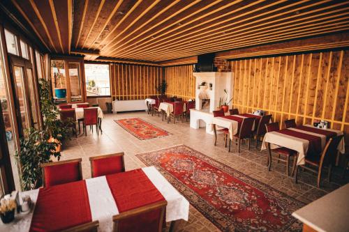 a restaurant with tables and chairs in a room at Maron Stone House in Goreme