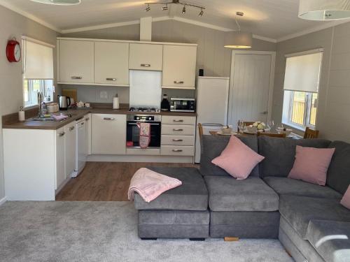 a living room with a couch and a kitchen at Hollicarrs - Newlands in York