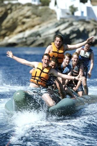 a group of people on a raft in the water at Paradise Apartments Studios in Mylopotas
