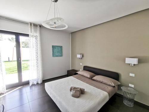a bedroom with a bed with a purse on it at Green Land Boutique Hotel in Castilenti