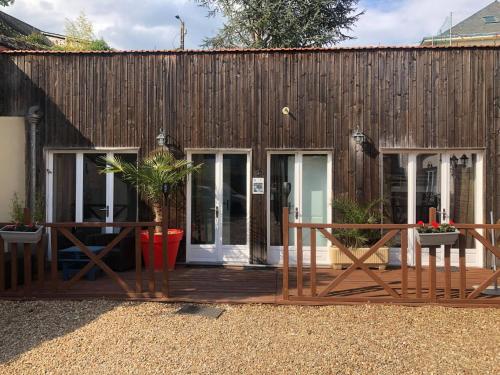 une maison dotée d'une terrasse en bois avec une table et des chaises dans l'établissement Chez Benjamin & Samantha - Les Portes du Château, à Azay-le-Rideau