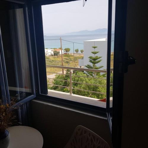 a window in a room with a view of a balcony at Sirene Villas in Dhiakofti