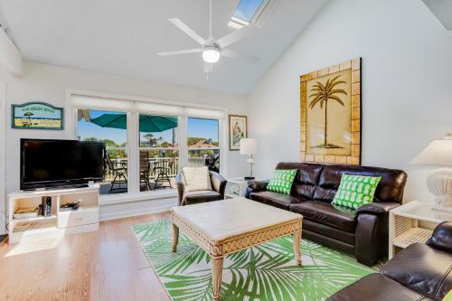 a living room with a couch and a tv at Beachside Drive 14 in Isle of Palms