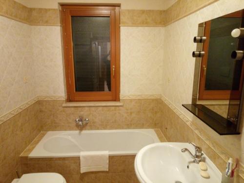 a bathroom with a tub and a sink and a toilet at A CASA DI LUCA E GLORIA 2 in Giulianova