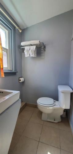 a bathroom with a white toilet and a sink at Travelers Inn in Flagstaff