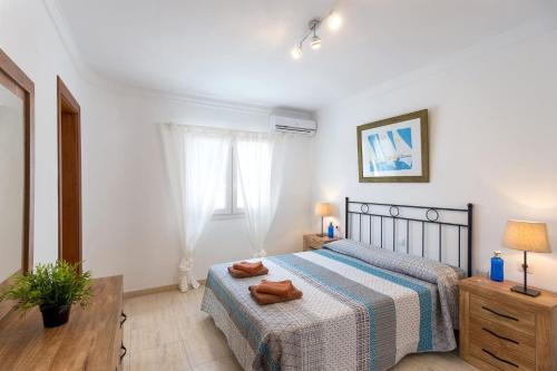 a bedroom with a bed with two towels on it at Villa Cancela by Villa Plus in Puerto del Carmen