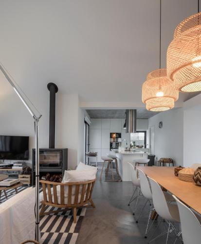 a living room and dining room with a table and chairs at Manos 114 in Comporta