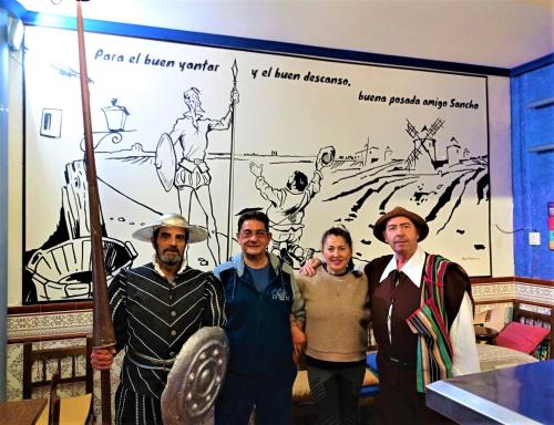 a group of men standing in front of a mural at Hostal Restaurante Ego's in Campo de Criptana