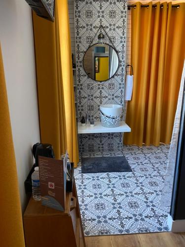 a bathroom with a shower with a sink and a mirror at La Rochelle et l'Aunis in Saint-Sauveur-dʼAunis