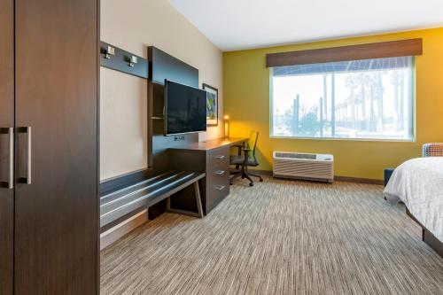 a hotel room with a bed and a flat screen tv at Holiday Inn Express & Suites - Phoenix Dwtn - State Capitol by IHG in Phoenix