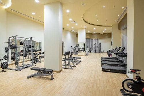 a gym with several treadmills and cardio machines at Millennium Makkah Al Naseem in Makkah