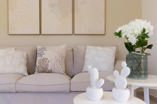 a living room with a couch and a table at °° VILLA ANNA°° in Villasimius