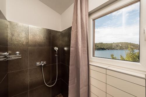 a bathroom with a shower and a window at Apartment Anita in Savar