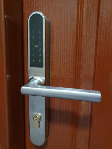 a close up of a door handle on a wooden door at Forest House in Dębica