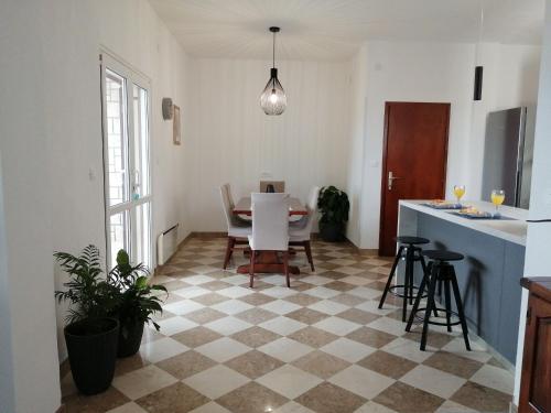 a kitchen and dining room with a table and chairs at Apartments Jelka in Postira