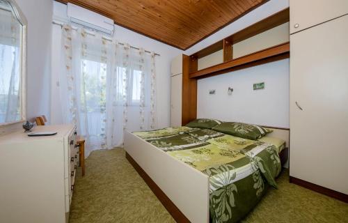 a bedroom with a bed and a window at House Predrag in Supetarska Draga