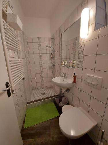 a small bathroom with a sink and a toilet at Apartma Viktorija in Portorož