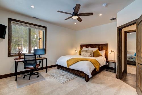 a bedroom with a bed and a desk and a ceiling fan at Default in Breckenridge