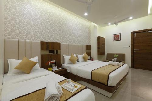 Ένα ή περισσότερα κρεβάτια σε δωμάτιο στο New Delhi Hotel Citizen