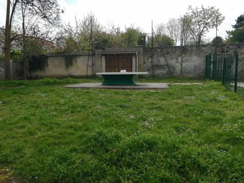 a bench in the middle of a grass field at Welcome Home in Linas