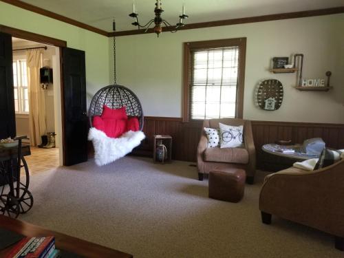 a living room with a santa pillow in a swing at Woodland Retreat - Wanderlust in Woodland