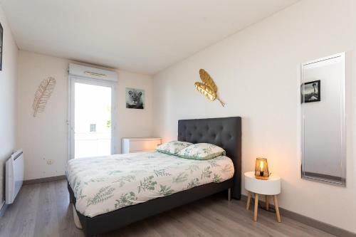 sypialnia z łóżkiem i oknem w obiekcie Appartement tout confort - Pau Nord w mieście Pau