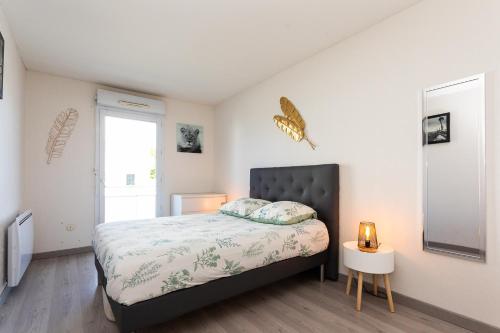 Ένα ή περισσότερα κρεβάτια σε δωμάτιο στο Appartement tout confort - Pau Nord
