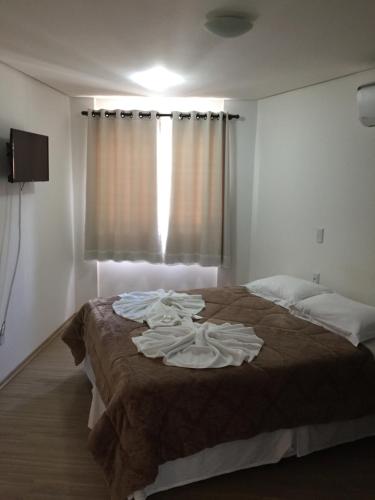 Ένα ή περισσότερα κρεβάτια σε δωμάτιο στο Pousada Beija Flor Centro
