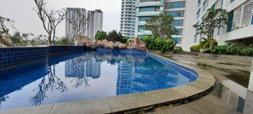 a swimming pool in a city with tall buildings at Grand Kamala Lagoon By Mitra Propertindo in Bekasi