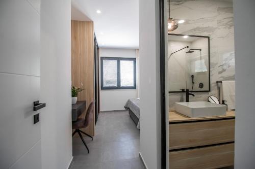 a bathroom with a sink and a mirror at Villa Sea Silhouette in Žman