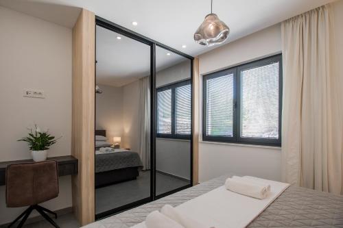 a bedroom with a bed and a mirror at Villa Sea Silhouette in Žman