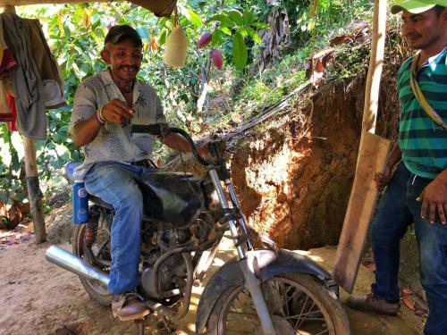 a man sitting on a motorcycle under a tent at Puerto Alto Hostel in Santa Marta