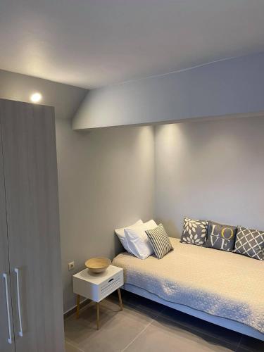 a small bedroom with a bed and a table at Marion Apartments in Kourouta