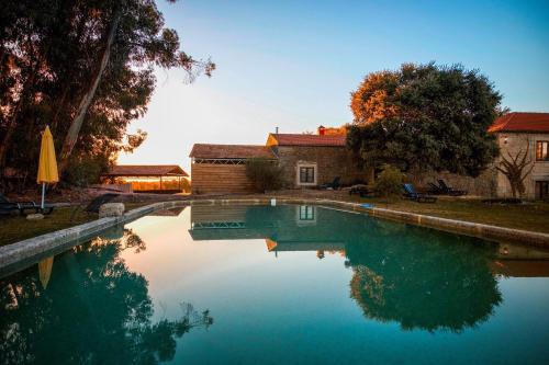 a swimming pool in front of a house at Quinta da Alma Cheia in Ninho do Açor